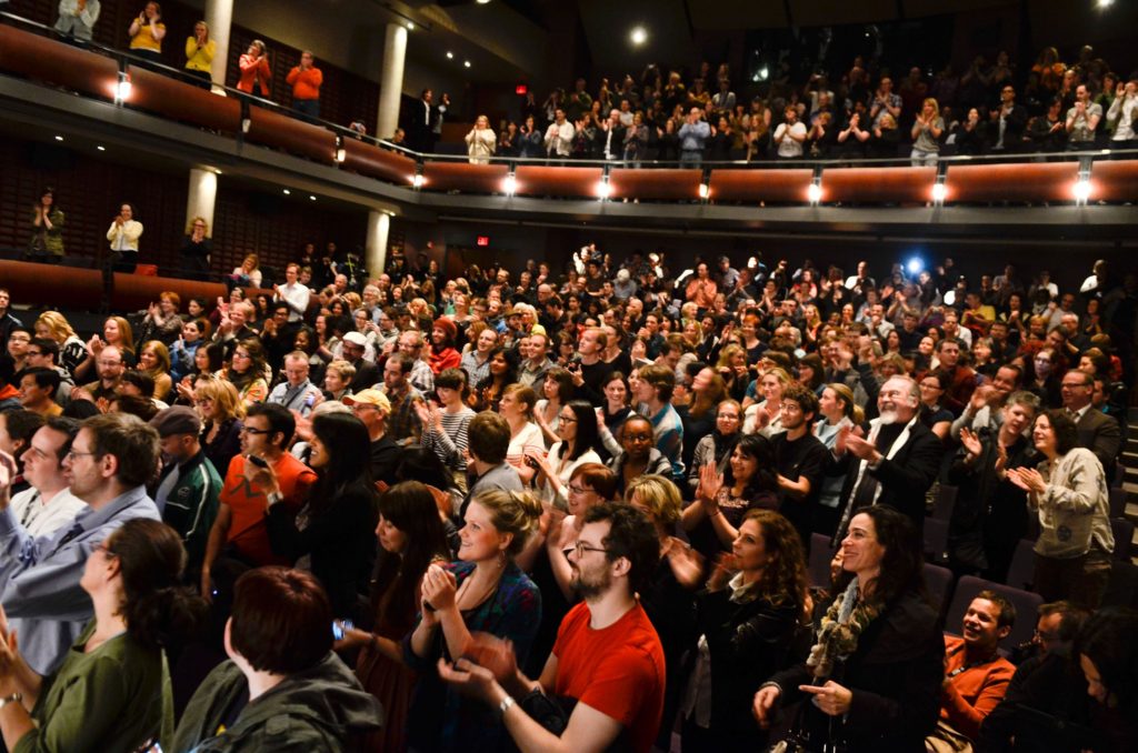 An audience appluading for a speech which ended really well