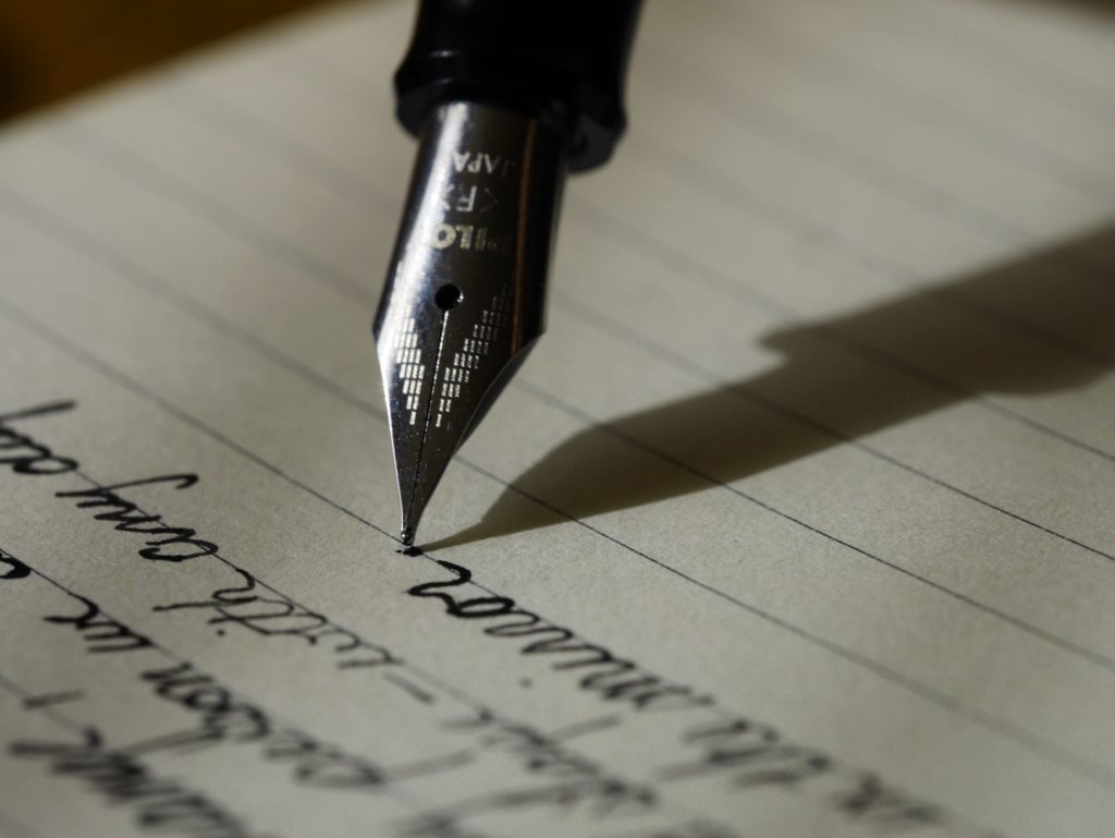 A person writing and practicing for a speech