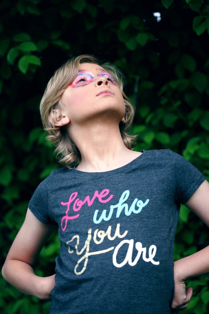 a kid who is sure of herself, standing in confidence now caring what other people might think